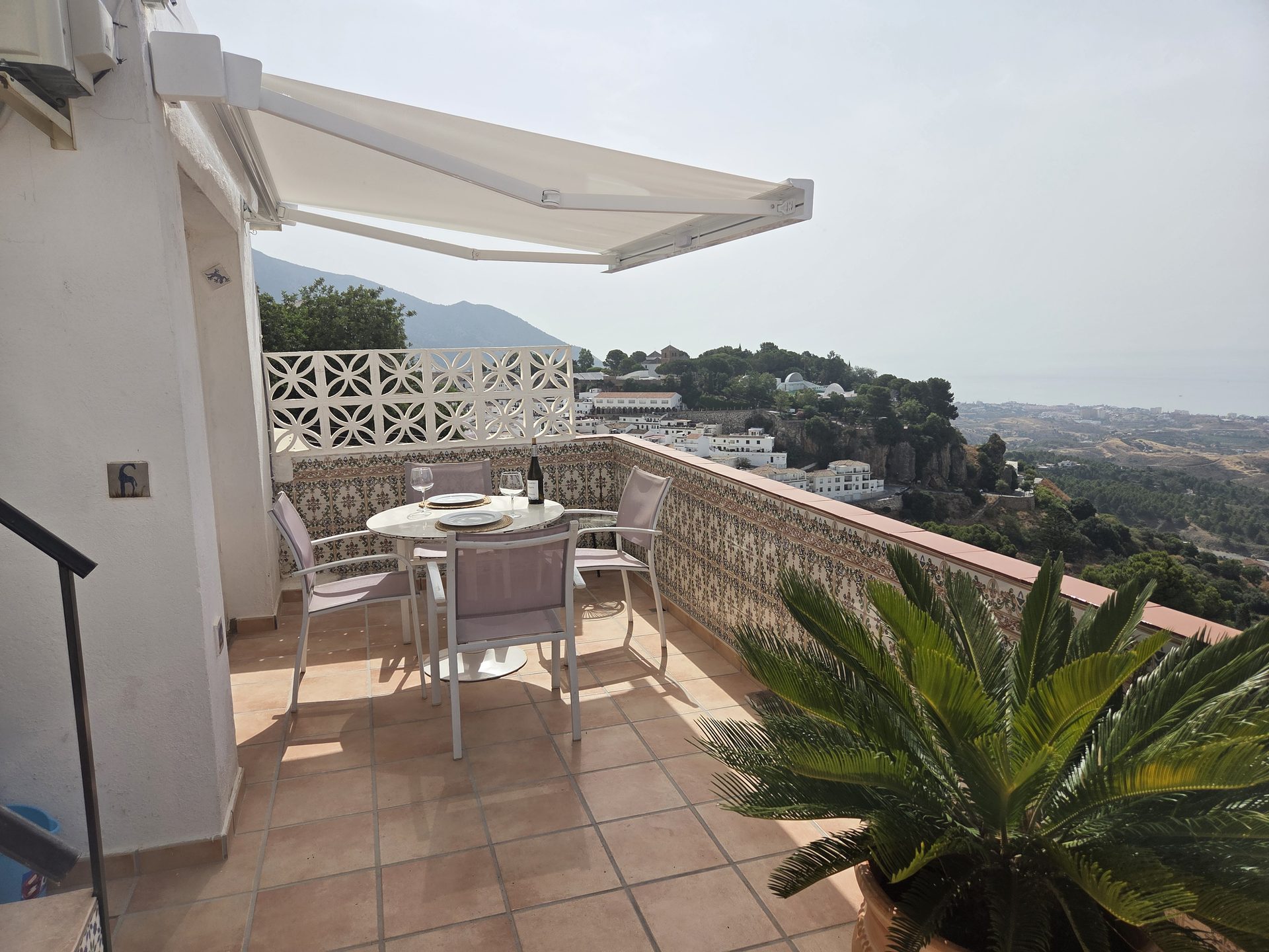 Private dining terrace with panoramic views across Mijas Pueblo and the Mediterranean
